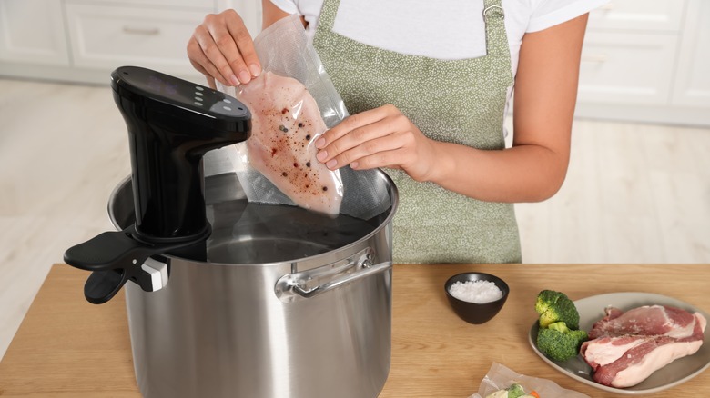 woman using sous vide machine