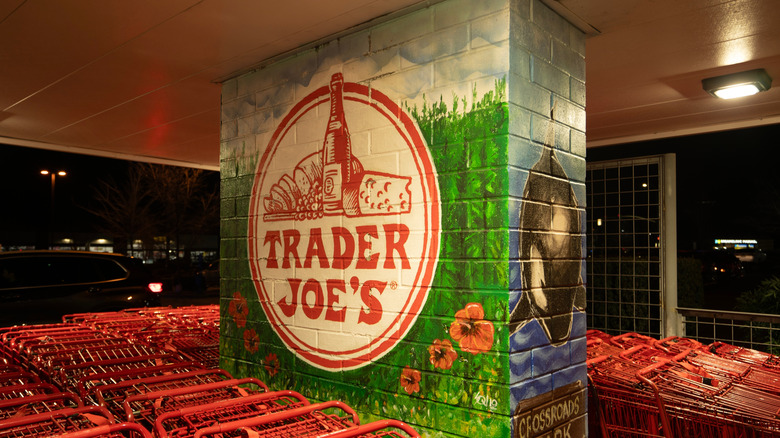 Cart return at Trader Joe's featuring a mural of the store's logo