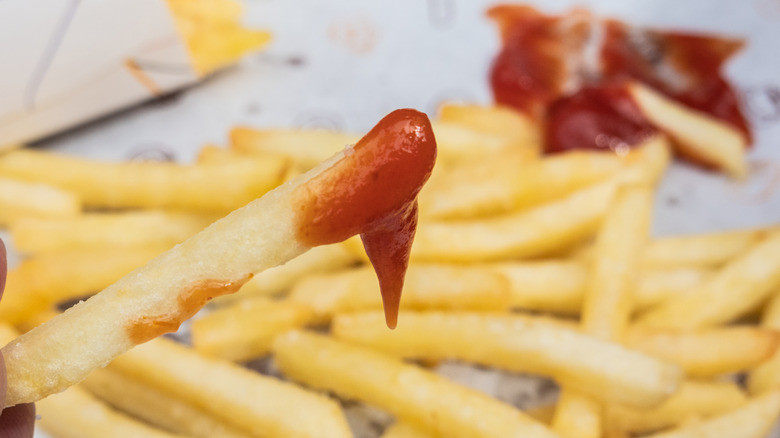Fries dipped in ketchup