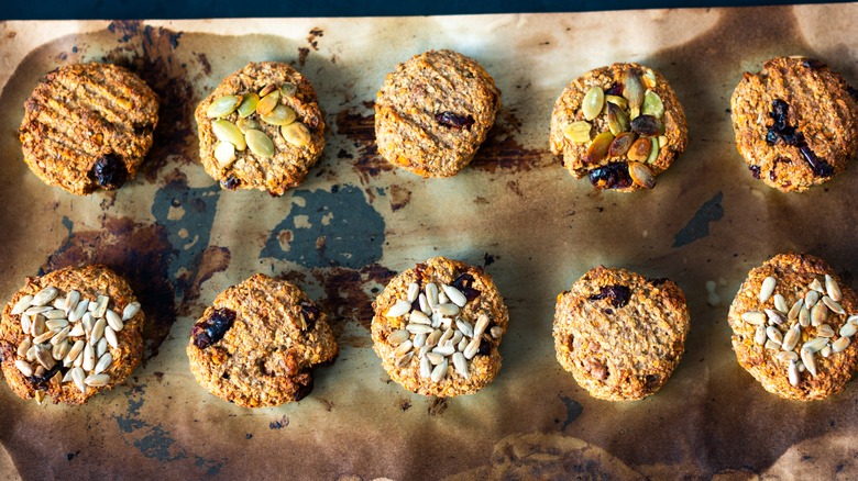 A tray of oatmeal cookies topped with seeds