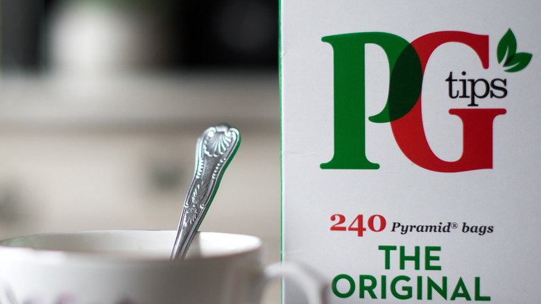 Box of PG Tips tea beside teacup