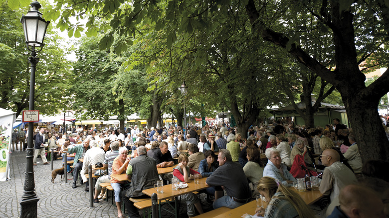 Busy beer garden with people at picnic tables