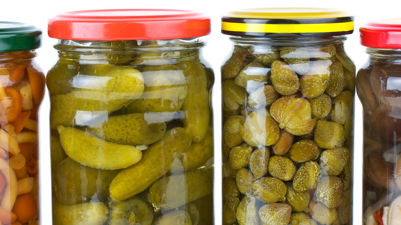 cornichons and capers in jars 