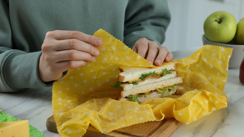 Woman packing a sandwich in beeswax wrap.