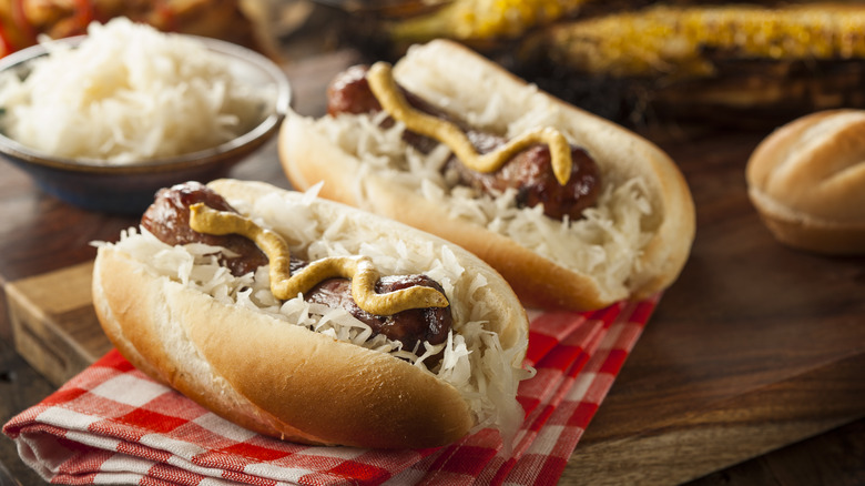 Brats on hot dog rolls with toppings