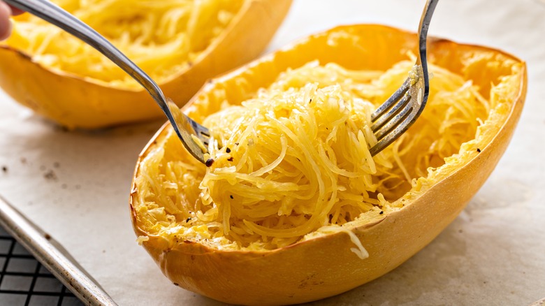 Baked spaghetti squash pulled apart by forks