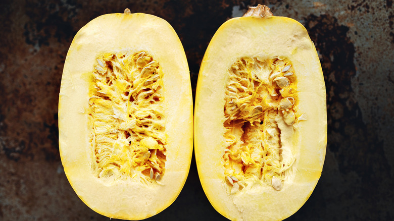 raw spaghetti squash on baking sheet