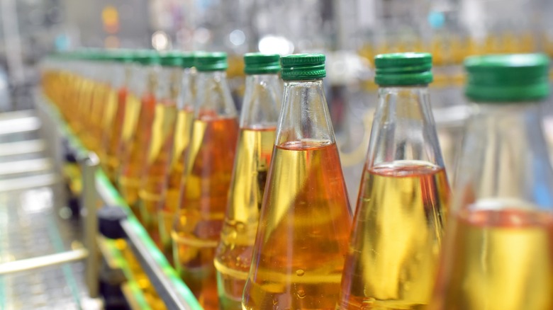 Glass bottles of apple juice in a factory