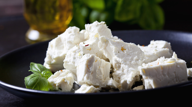 Crumbled feta on black plate