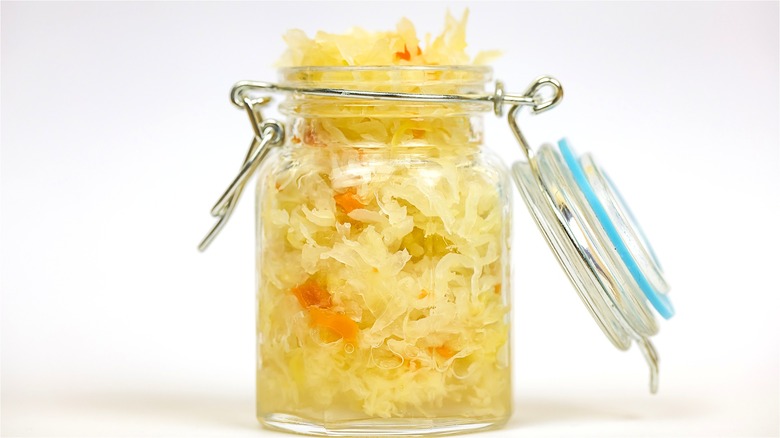 A a jar of sauerkraut with the lid open