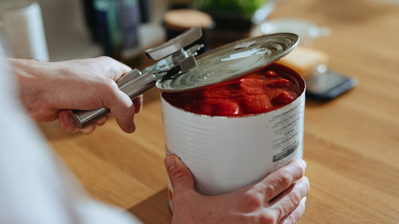 Can of tomato sauce being opened