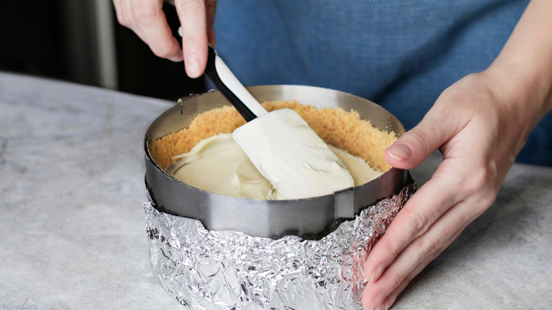 smoothing cheesecake into a pan