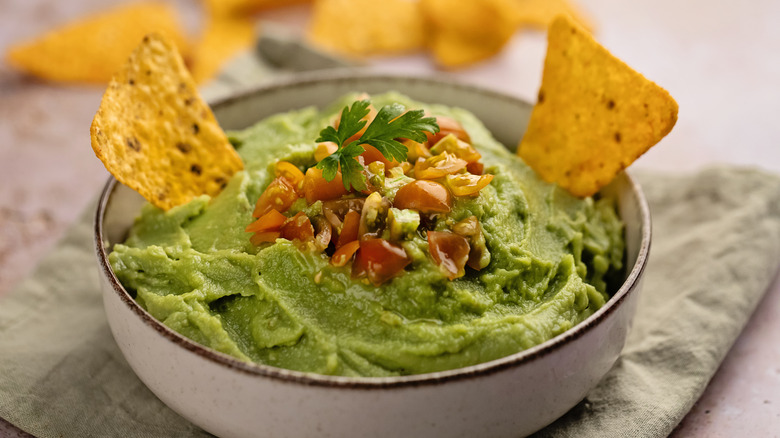 guacamole in a bowl with chips