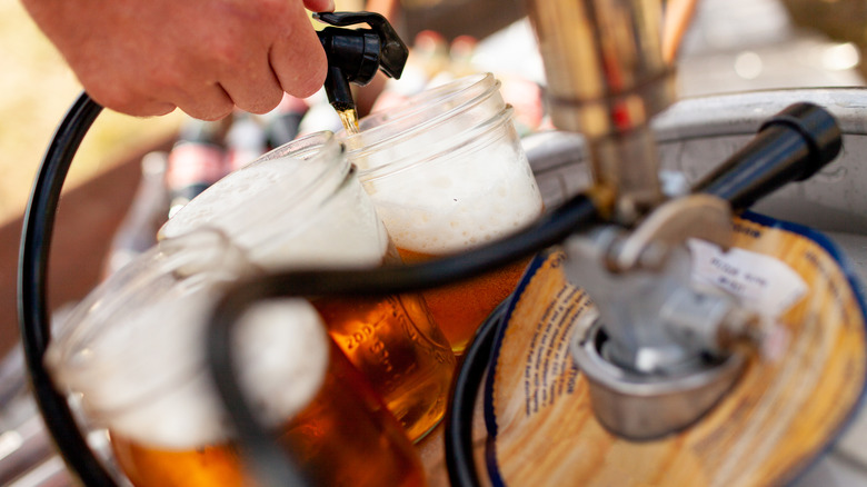 Person pouring beer from keg