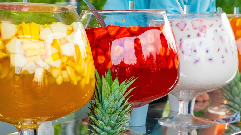 Multicolored punch flavors in glass bowls