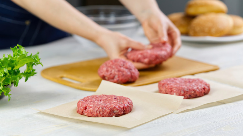 woman forming burgers