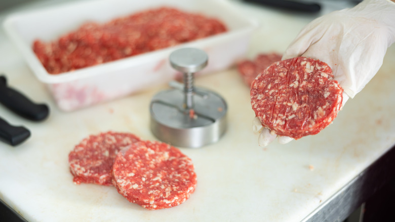 butcher crafting burger patties