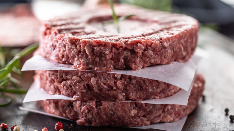 burgers stacked between parchment paper