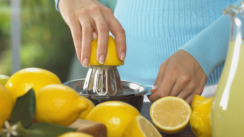 Person juicing a lemon