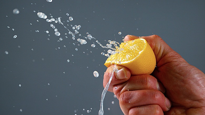 Person squeezing a lemon