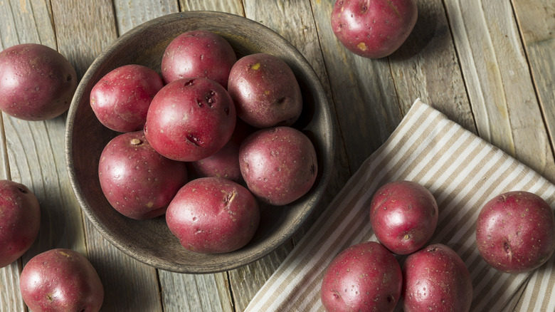 Red potatoes on a brown wooden table