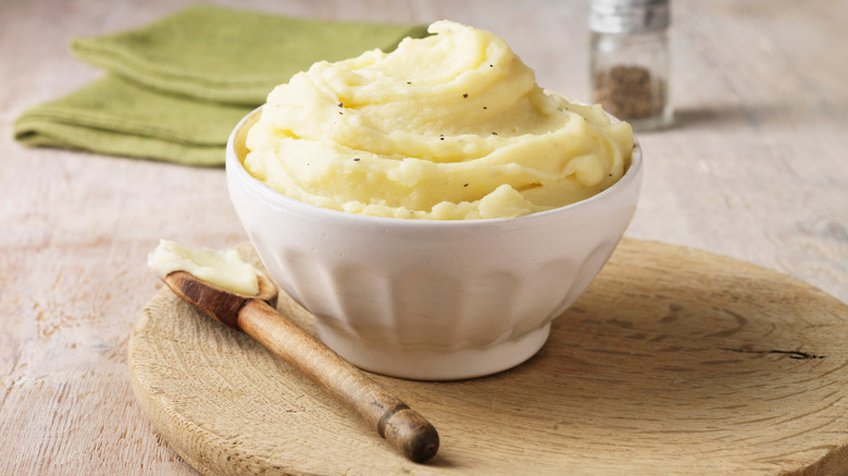 Mashed potatoes with wooden spoon