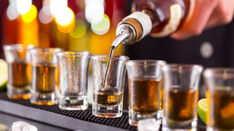 Pouring liquor into shot glasses