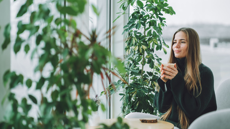 A woman sits in a cafe with a latte