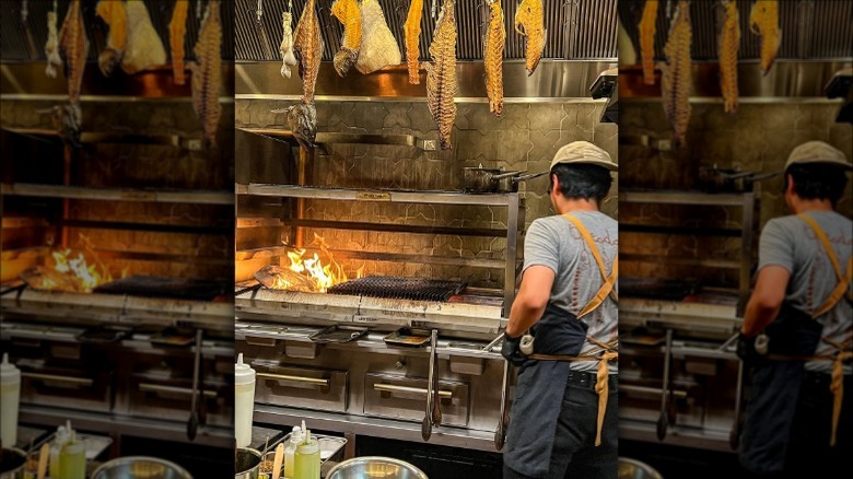 The open kitchen at Theodora in Brooklyn with hanging fish skeletons and Josper grill