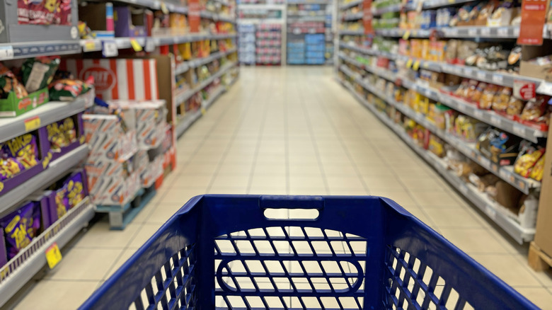 shopping cart at end of a grocery aisle