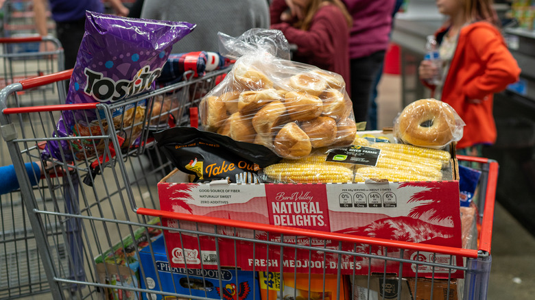 A Costco shopping cart full of bulk food items