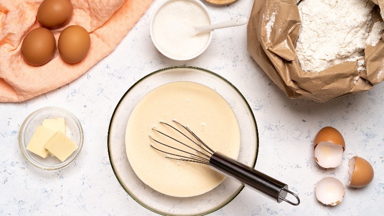 Perfectly mixed pancake batter surrounded by ingredients