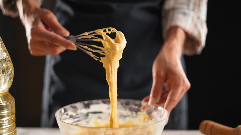 Man over-whisking batter