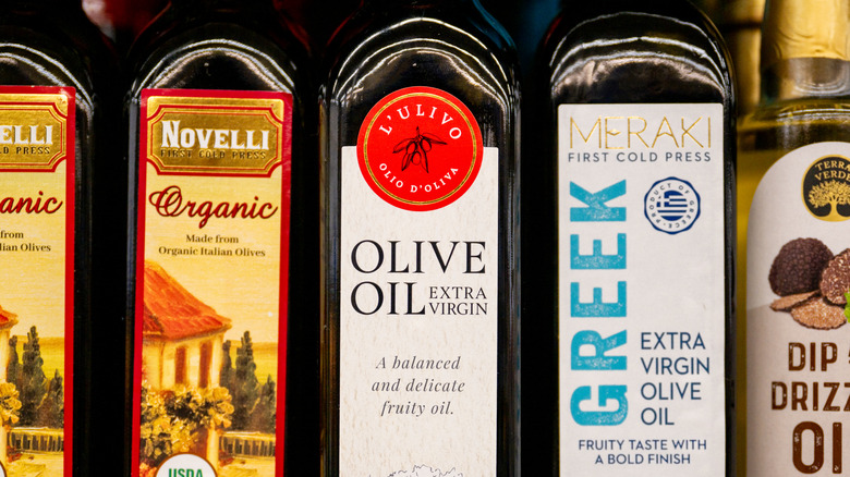 Bottles of olive oil on shelf