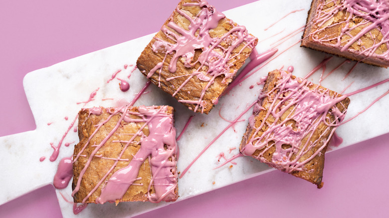 pink blondie brownies on a board