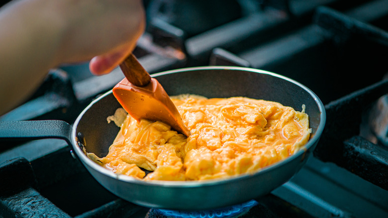 scrambled eggs cooking in pan