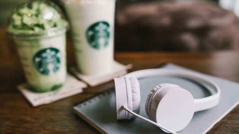 Headphones and Starbucks drinks on a table