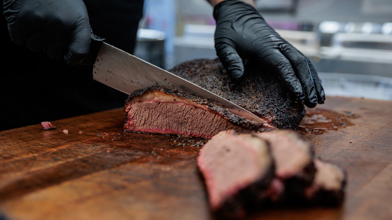 Texas style brisket sliced on cutting board