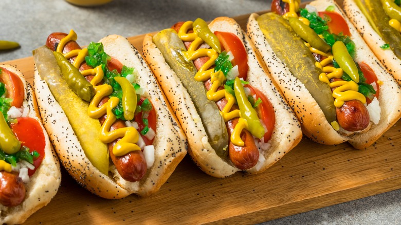 Chicago-style hot dogs on a wooden tray