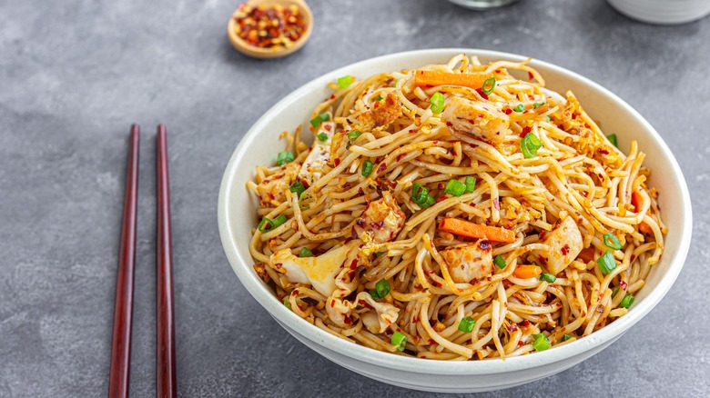 Bowl of chow mein on a table.