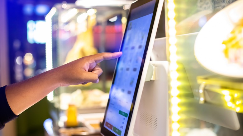 Person using a self-serve kiosk