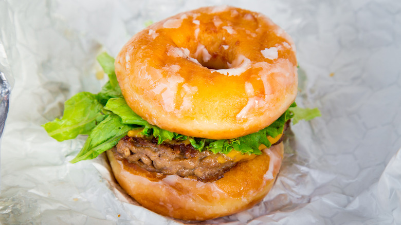 A cheeseburger in a doughnut bun