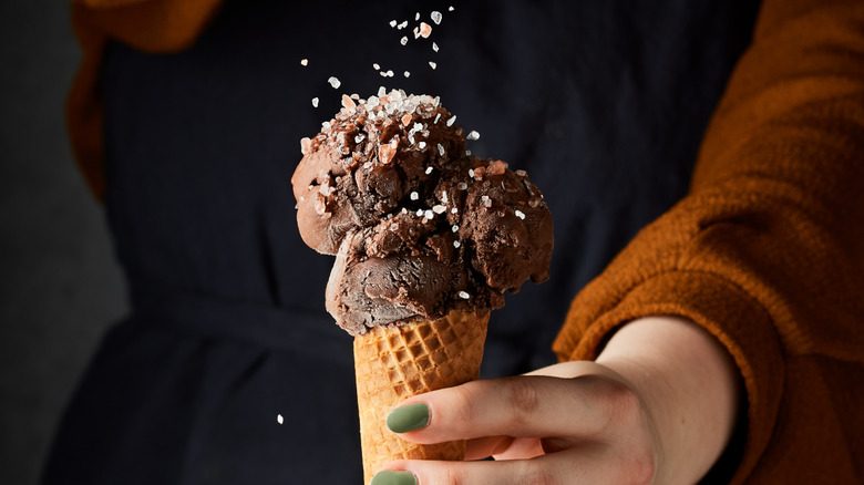 Woman sprinking sea salt on ice cream