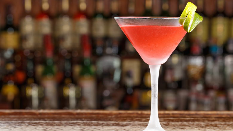 Pink cosmopolitan cocktail in glass on a bar