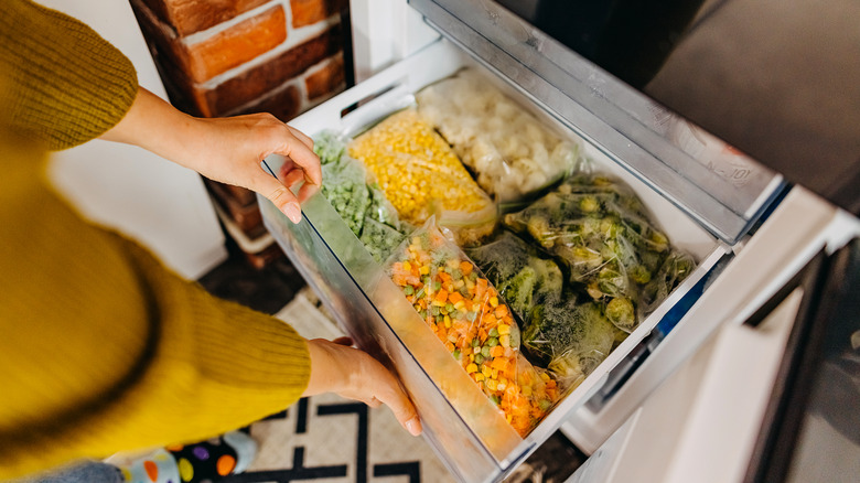 Freezer drawer full of various frozen vegetables