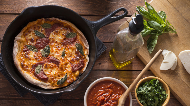 Cast iron pizza with basil as garnish