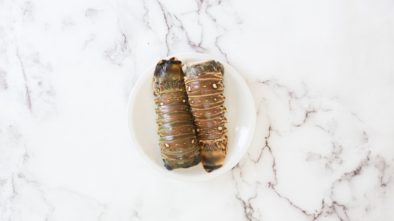 Two lobster tails on white plate