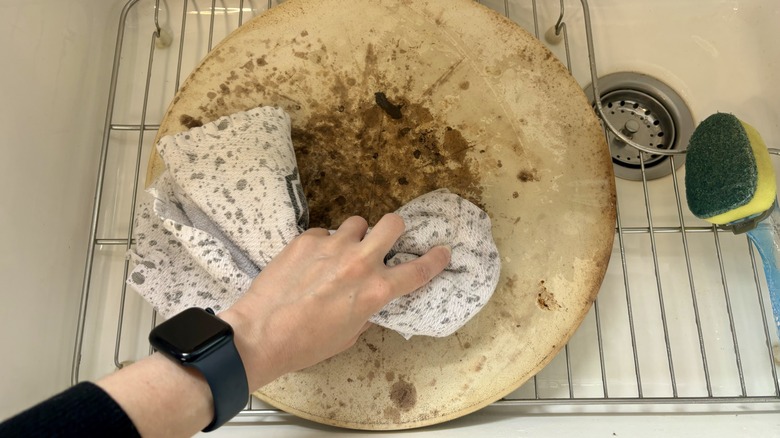 wiping down pizza stone