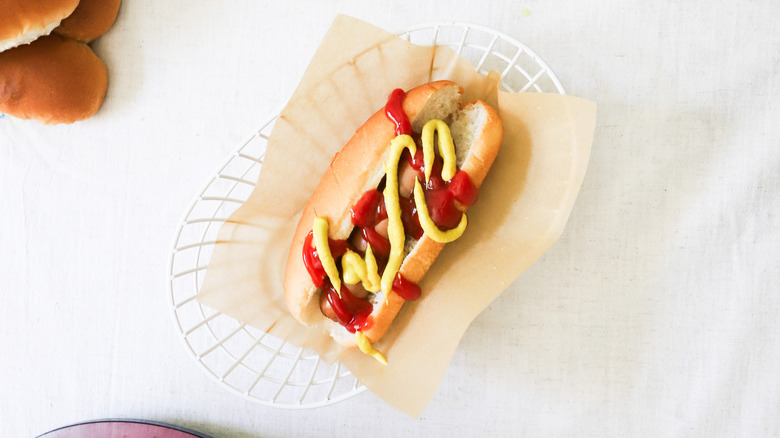 Hot dog topped with condiments