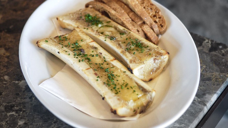 Grilled bone marrow with bread.